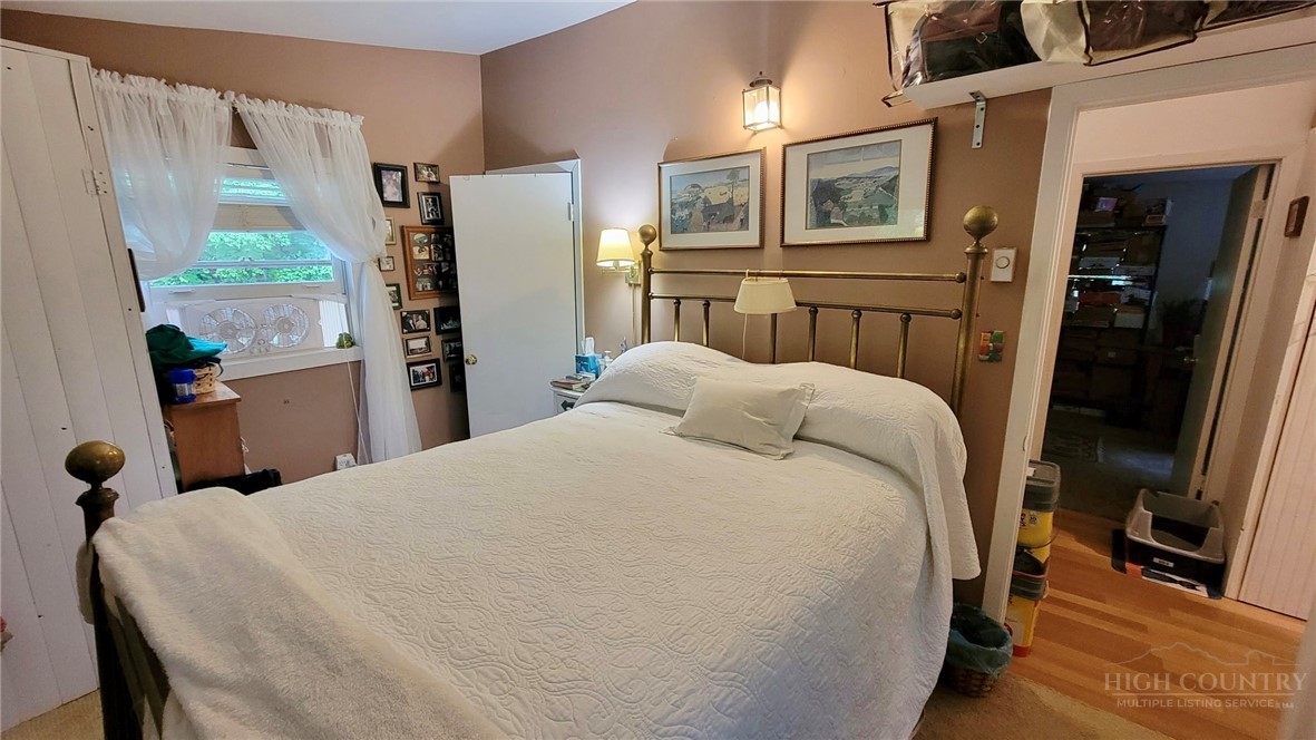 111 Locust Ridge Road Beech Mountain, NC 28604 - Photo 10 of 21 a bedroom with a bed and a refrigerator