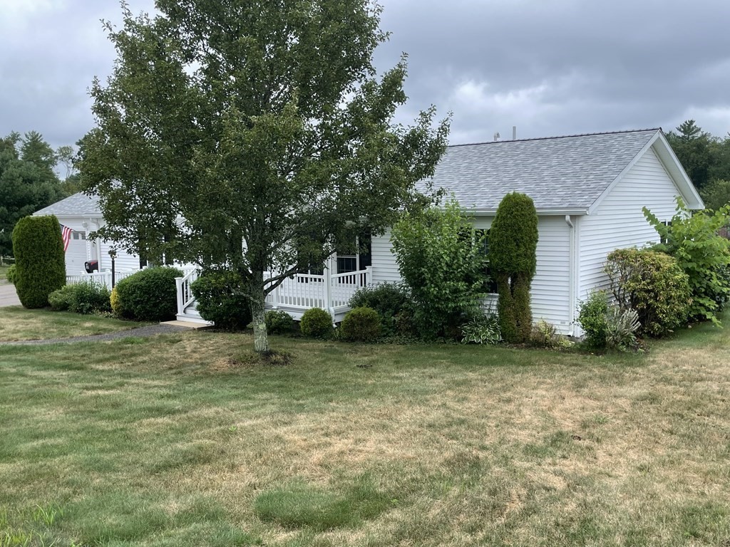 3006 Green Street Middleboro, MA 02346 - Photo 4 of 34 a front view of a house with a garden and tree