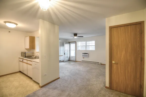 an empty room with windows and pillars in it