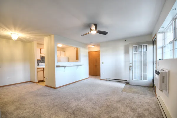 a view of an empty room with a kitchen