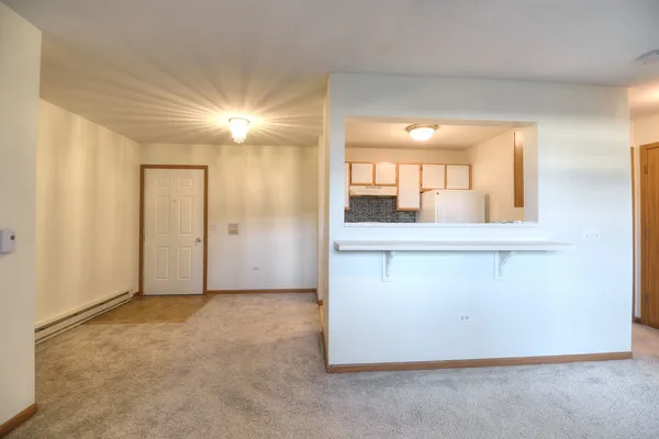 an empty room with a bathroom and mirror