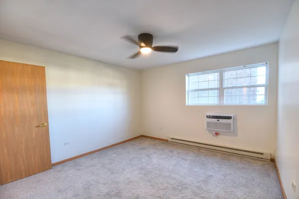 an empty room with a empty space and a ceiling fan
