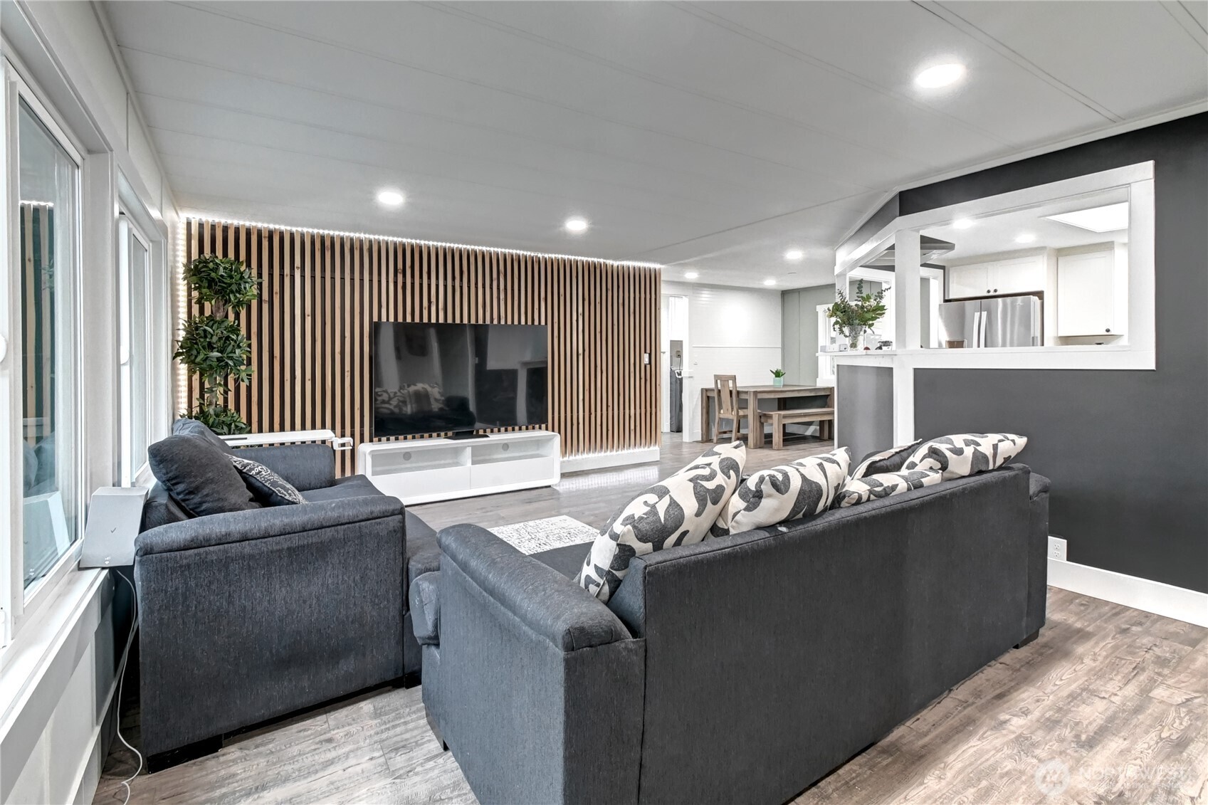 1615 208th Street Southeast, Unit 42 Bothell, WA 98012 - Photo 8 of 32 a living room with furniture and a flat screen tv
