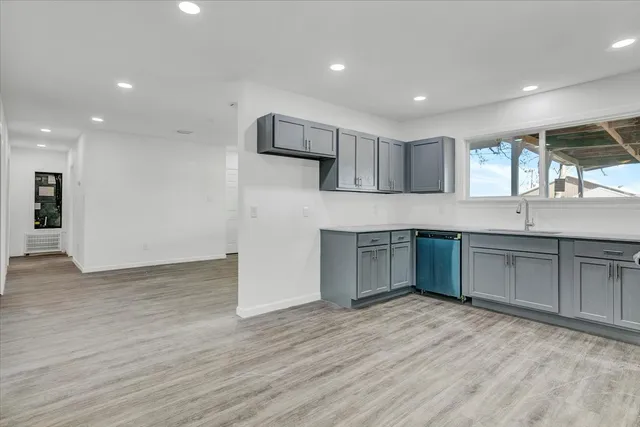 a kitchen with a refrigerator and a sink