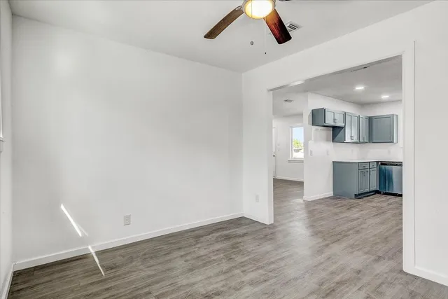 a view of a kitchen with wooden floor and a kitchen