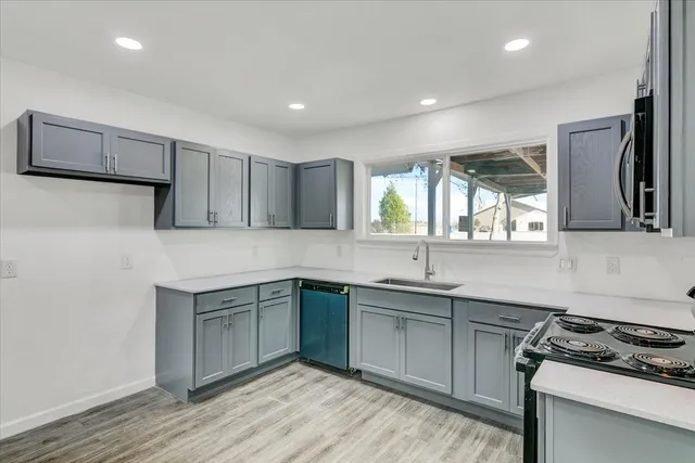 a kitchen with a sink stove and cabinets