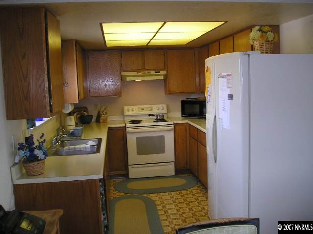 1374 Antelope Valley Road Reno, NV 89506 - Photo 3 of 9 a kitchen with a refrigerator and a stove