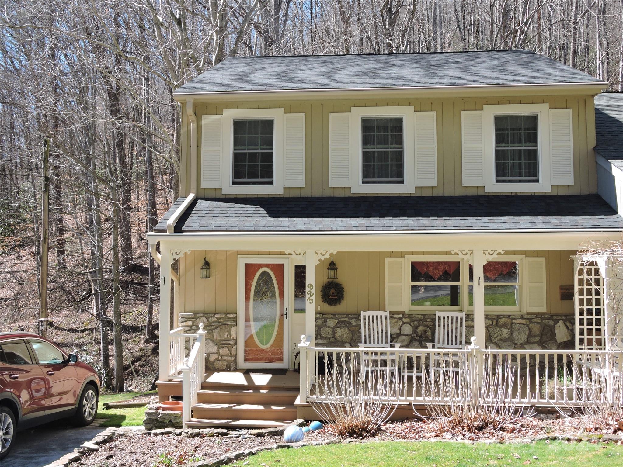 329 Riddle Cove Road Maggie Valley, NC 28751 - Photo 1 of 22 a front view of a house with a yard