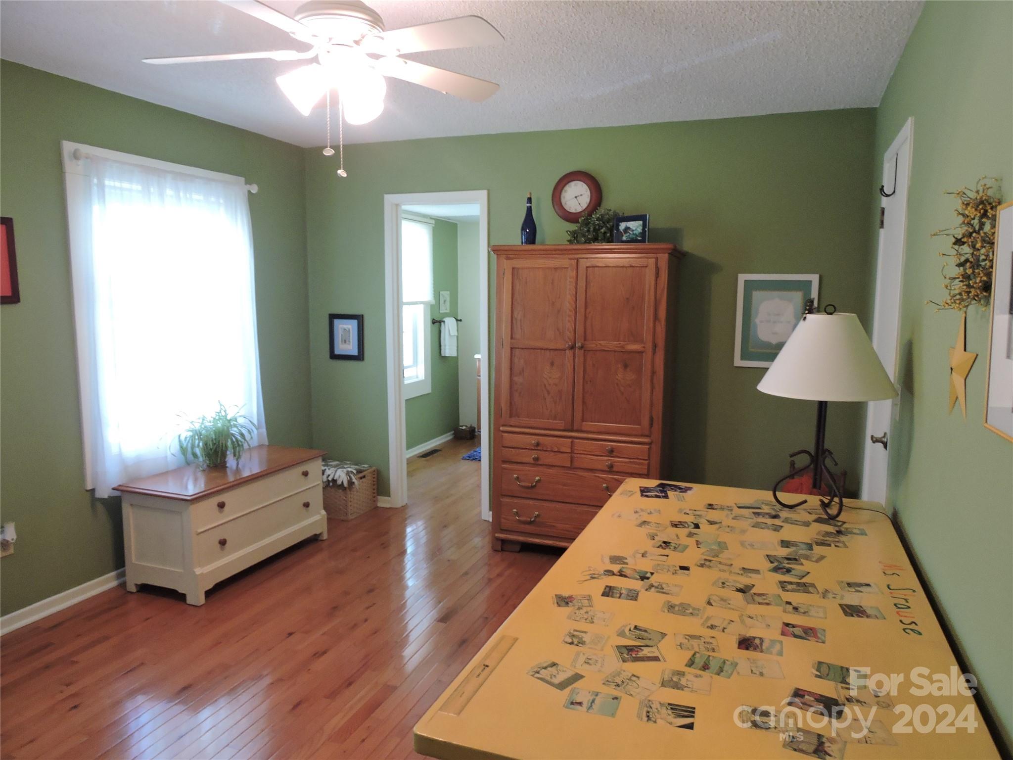 329 Riddle Cove Road Maggie Valley, NC 28751 - Photo 14 of 22 a bedroom with a bed and a lamp
