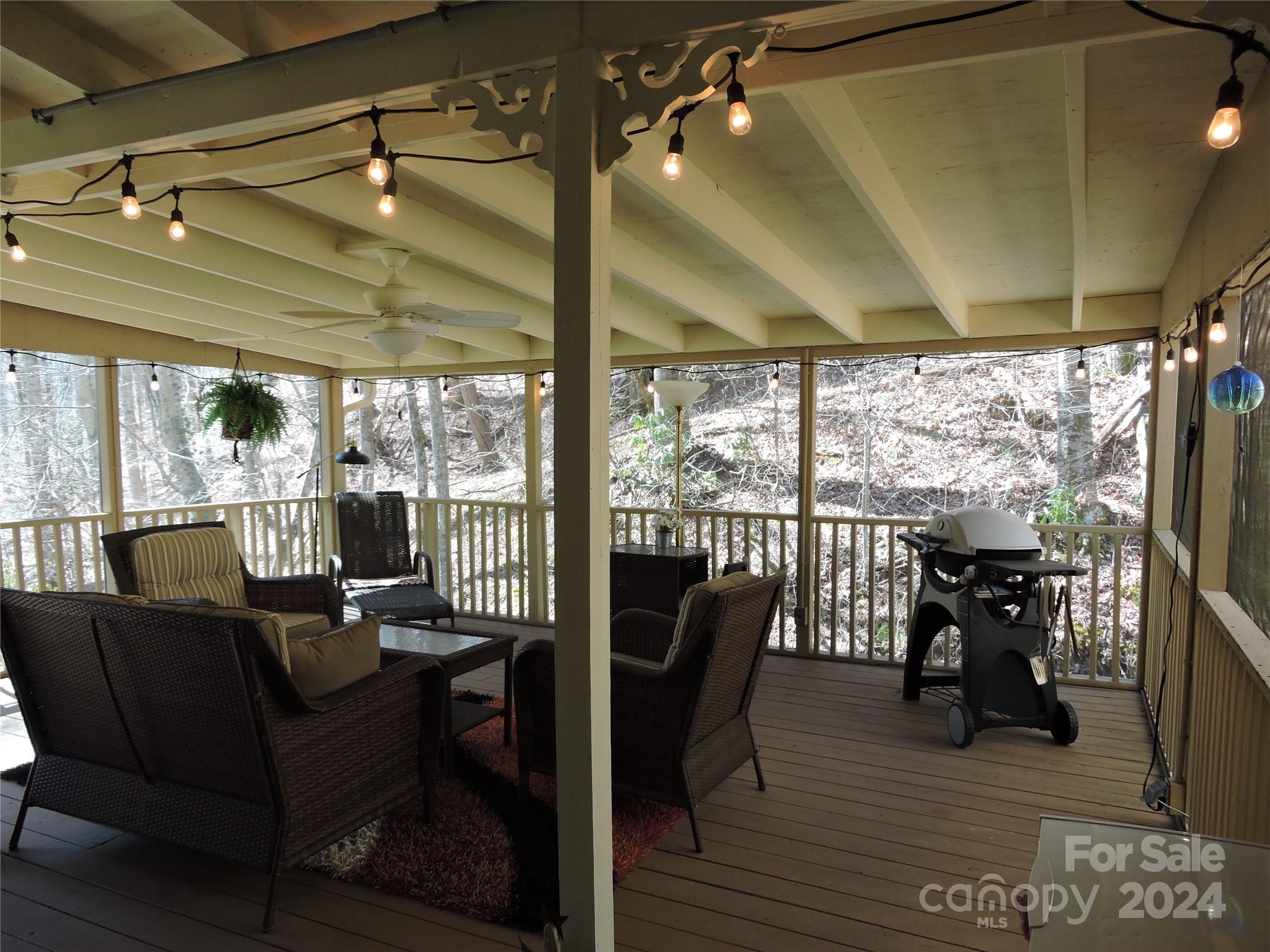 329 Riddle Cove Road Maggie Valley, NC 28751 - Photo 17 of 22 a living room with furniture and a floor to ceiling window