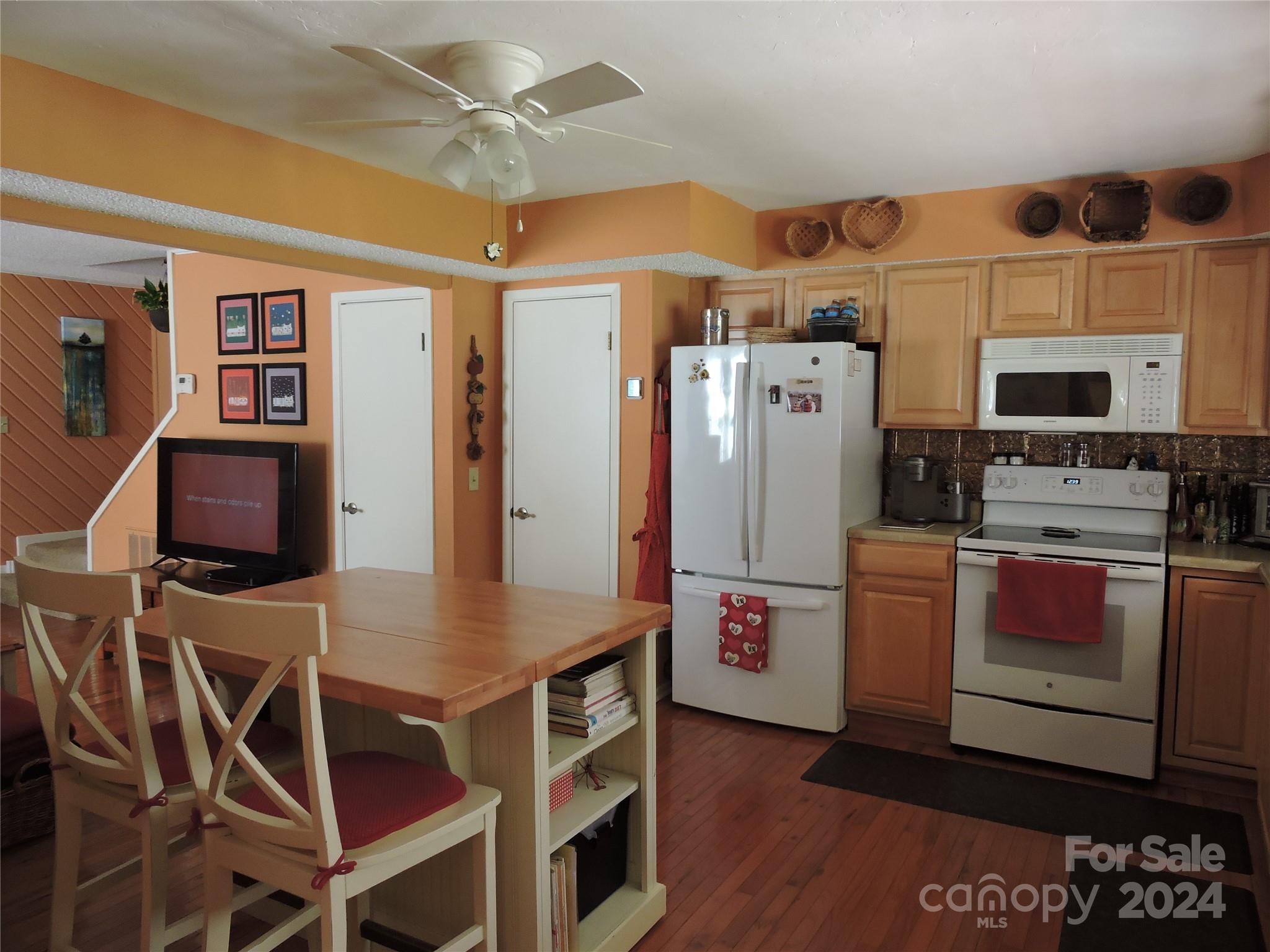 329 Riddle Cove Road Maggie Valley, NC 28751 - Photo 3 of 22 a kitchen with stainless steel appliances a stove a refrigerator and a refrigerator