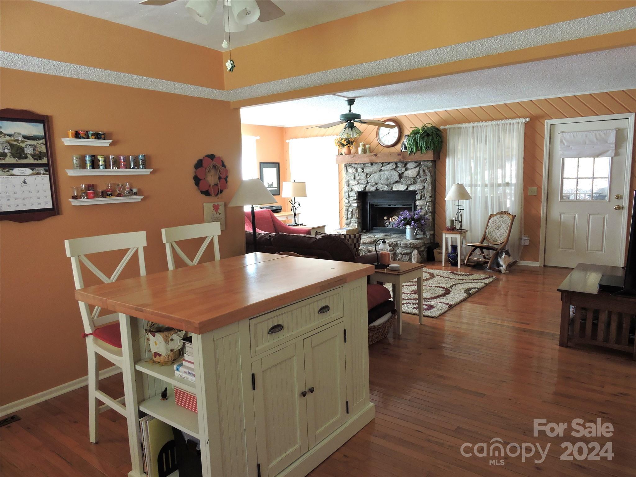 329 Riddle Cove Road Maggie Valley, NC 28751 - Photo 4 of 22 a view of a dining room with furniture window and wooden floor