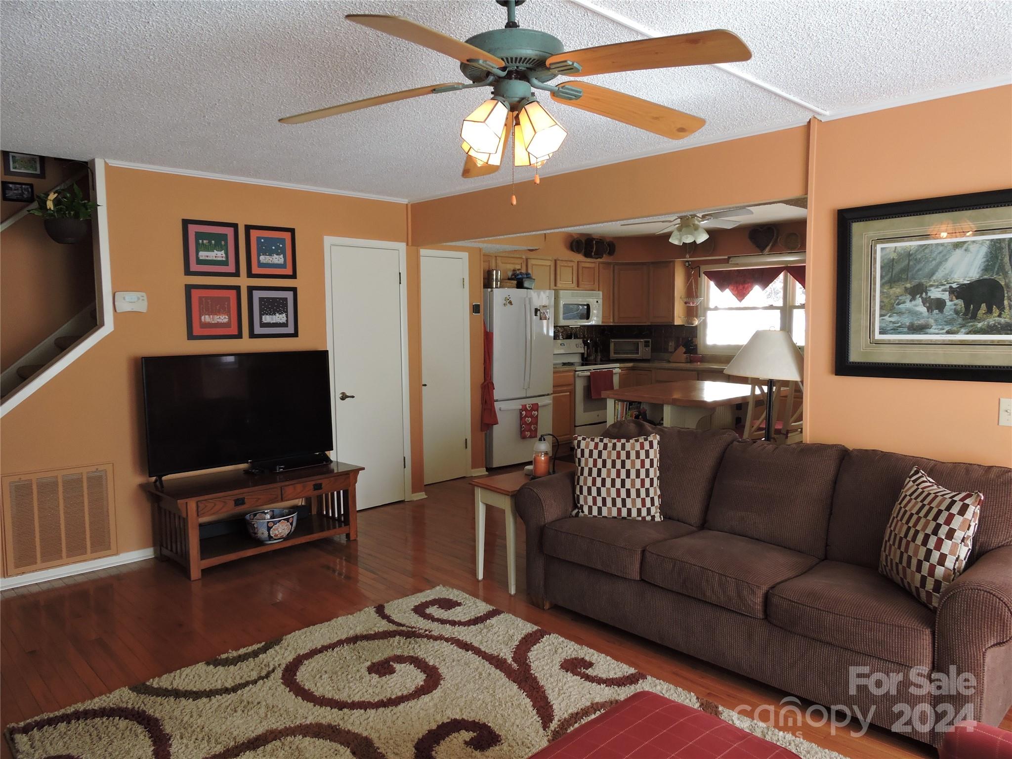 329 Riddle Cove Road Maggie Valley, NC 28751 - Photo 7 of 22 a living room with furniture and a flat screen tv