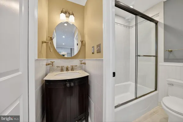 a bedroom with a bed lamp closet and window