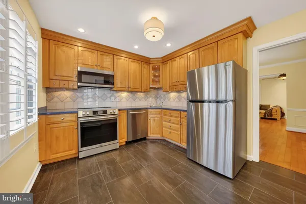 a kitchen with granite countertop a stove top oven cabinetry a sink and dishwasher
