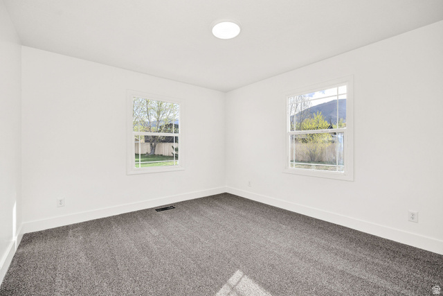 4155 Johnson Road Nibley, UT 84321 - Photo 23 of 71 Spare room with dark colored carpet and healthy amount of natural light