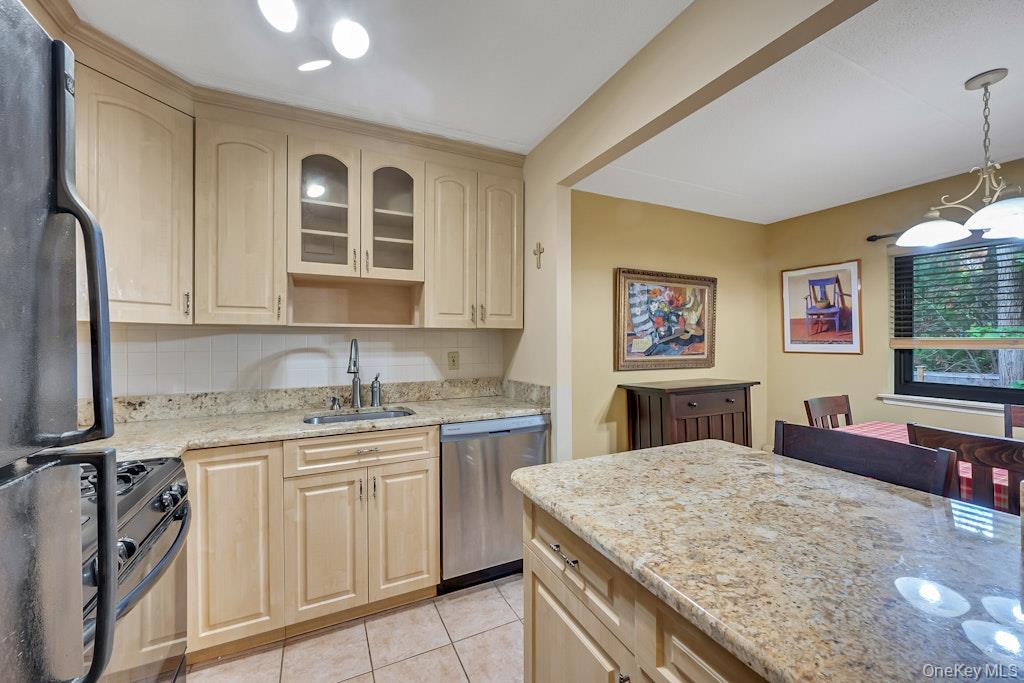 108 Sagamore Road, Unit 5E Tuckahoe, NY 10707 - Photo 17 of 23 a kitchen with stainless steel appliances granite countertop a sink and cabinets