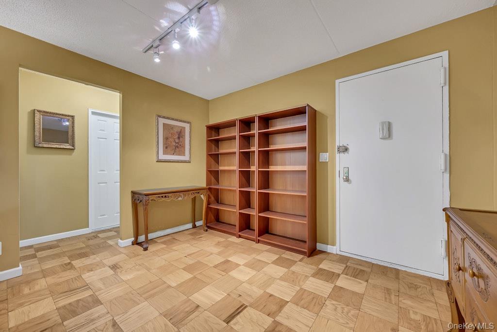 108 Sagamore Road, Unit 5E Tuckahoe, NY 10707 - Photo 4 of 23 a view of an empty room with shelves and wooden shelves