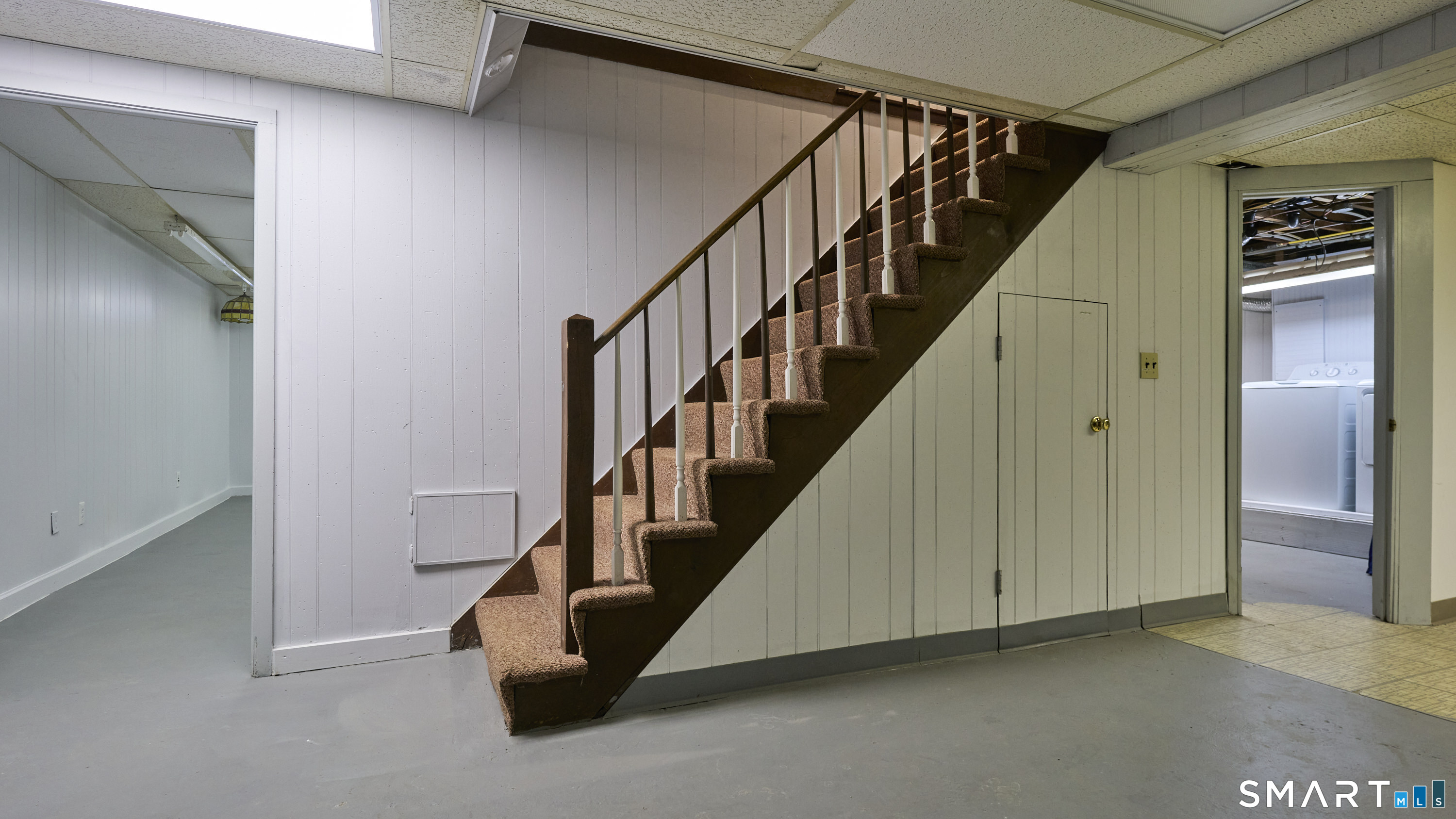 15 Haywardville Road East Haddam, CT 06423 - Photo 36 of 40 Lower-level staircase - Defined transition to recreation space - separates living and leisure zones and access to laundry center to the right.