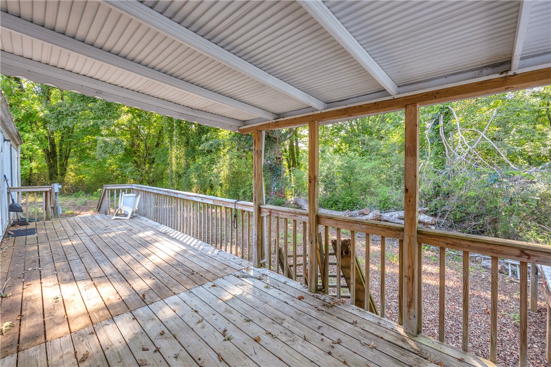 150 Newberry Road Walhalla, SC 29691 - Photo 24 of 47 An inviting wood deck extends into a lush, green landscape, offering a private outdoor retreat.