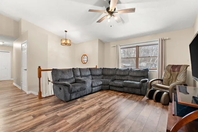 a living room with furniture and a wooden floor