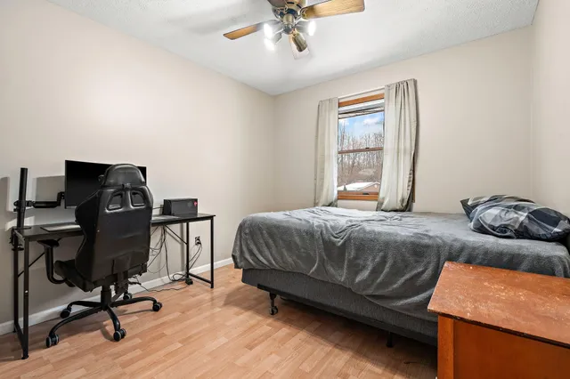 a bedroom with a bed and a desk