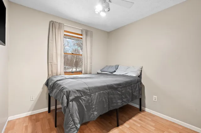 a bedroom with a bed and window