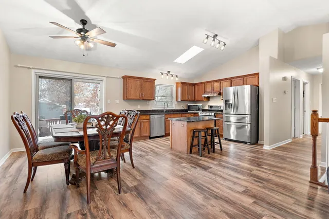 a view of a dining room with furniture and a kitchen