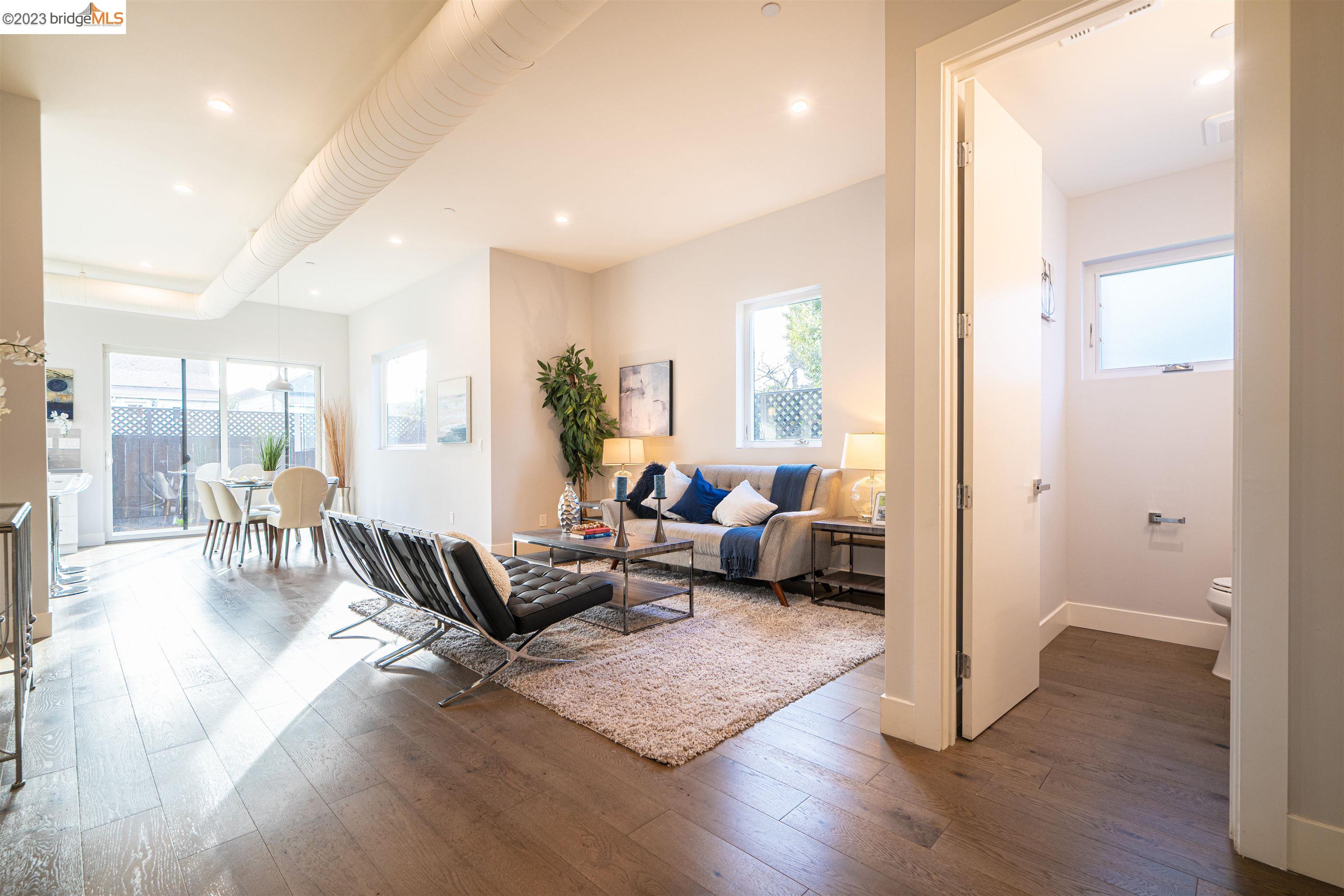 1679 12th Street Oakland, CA 94607 - Photo 1 of 26 a living room with furniture and a wooden floor