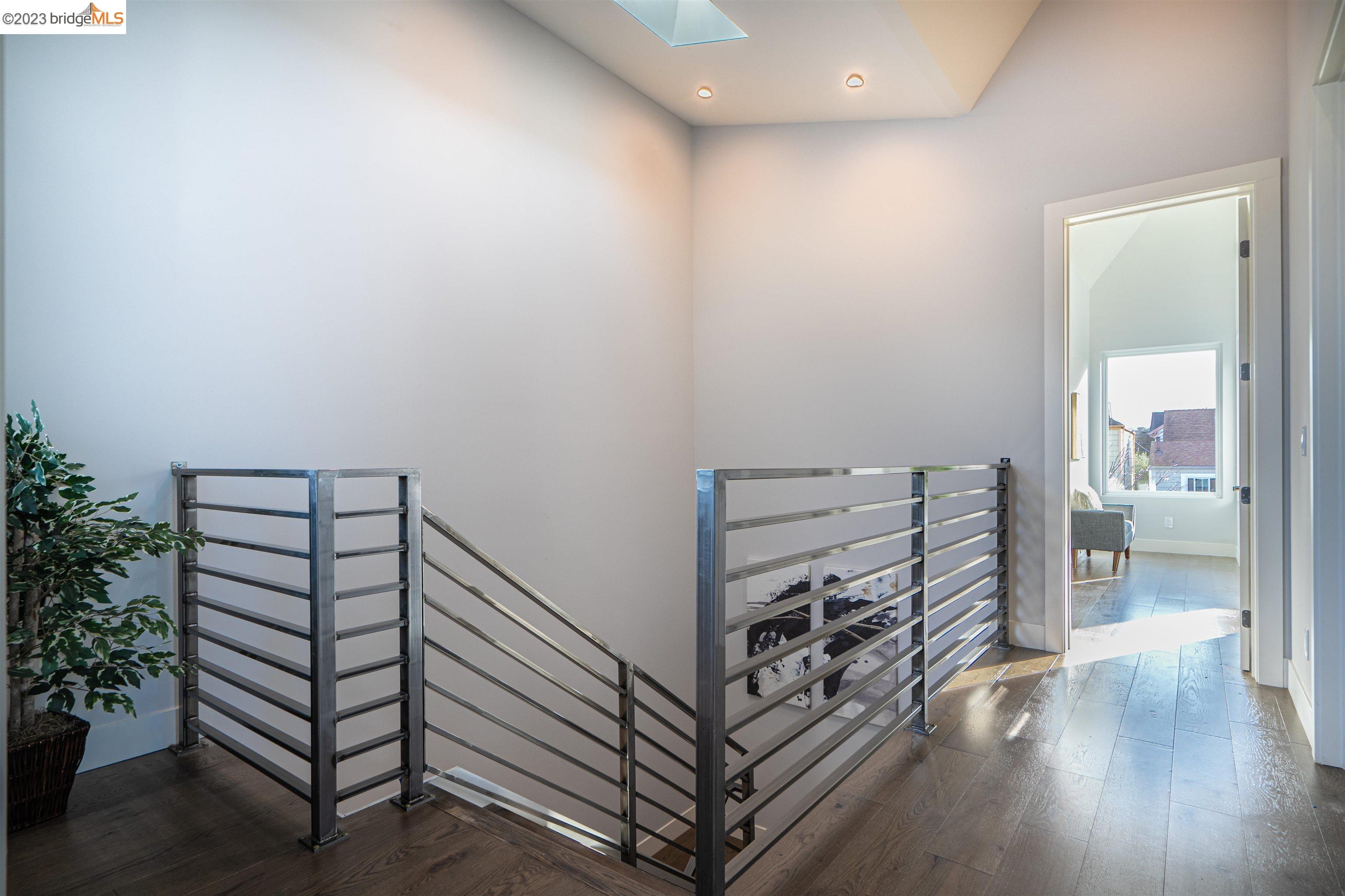 1679 12th Street Oakland, CA 94607 - Photo 12 of 26 a view of a hallway with wooden floor and stairs