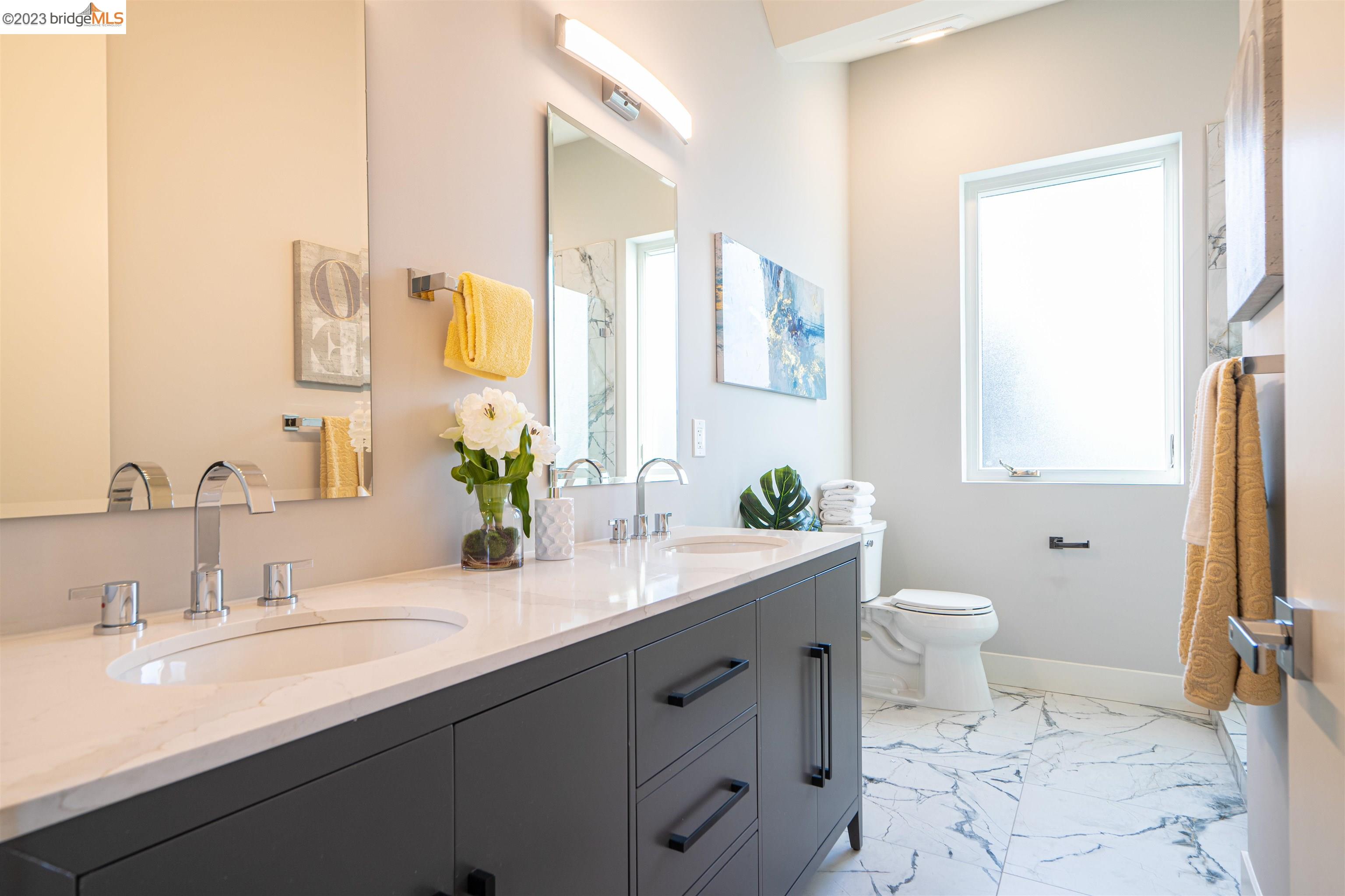 1679 12th Street Oakland, CA 94607 - Photo 13 of 26 a bathroom with a granite countertop sink mirror and a toilet