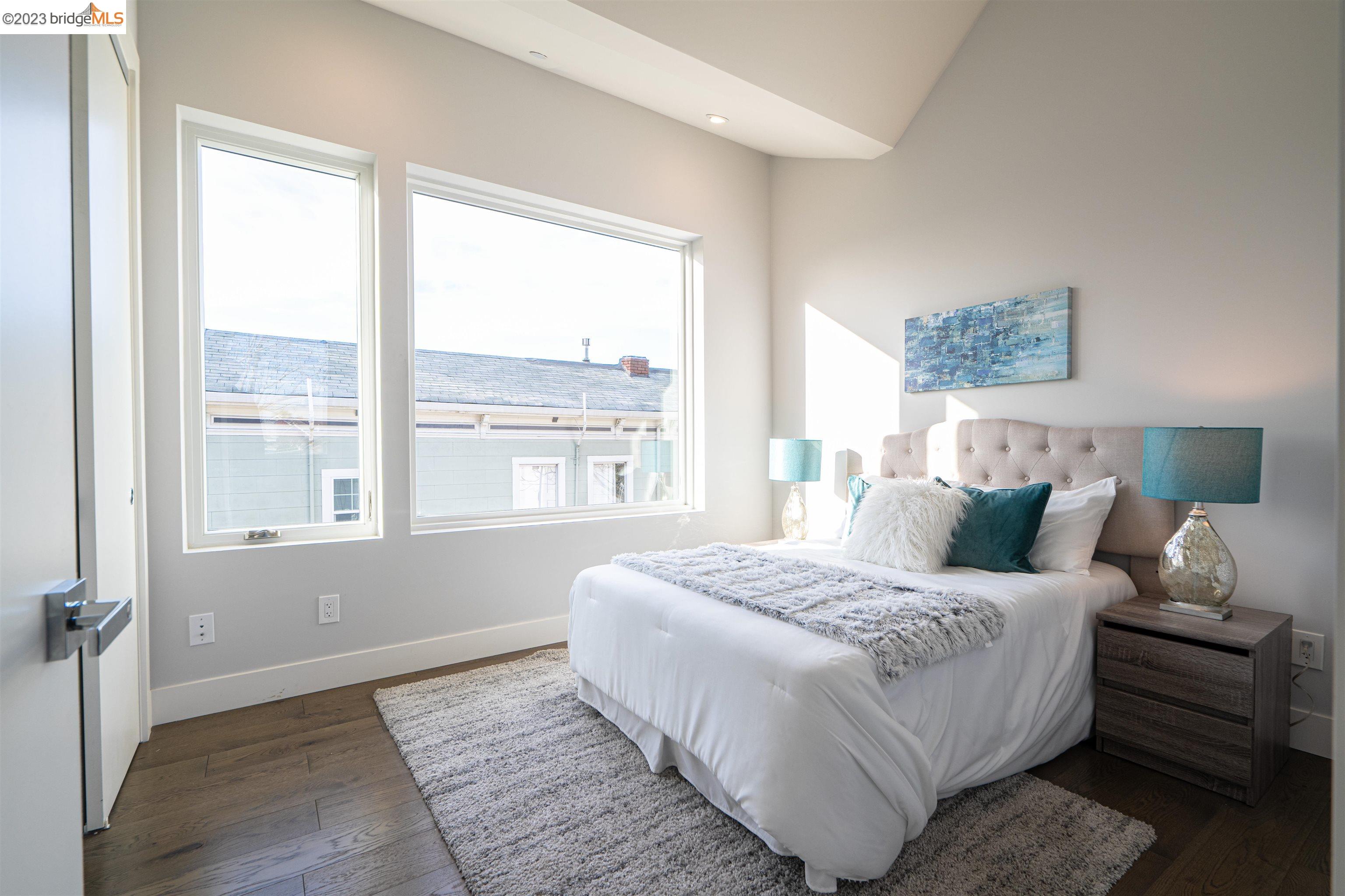 1679 12th Street Oakland, CA 94607 - Photo 16 of 26 a bedroom with a bed and a large window