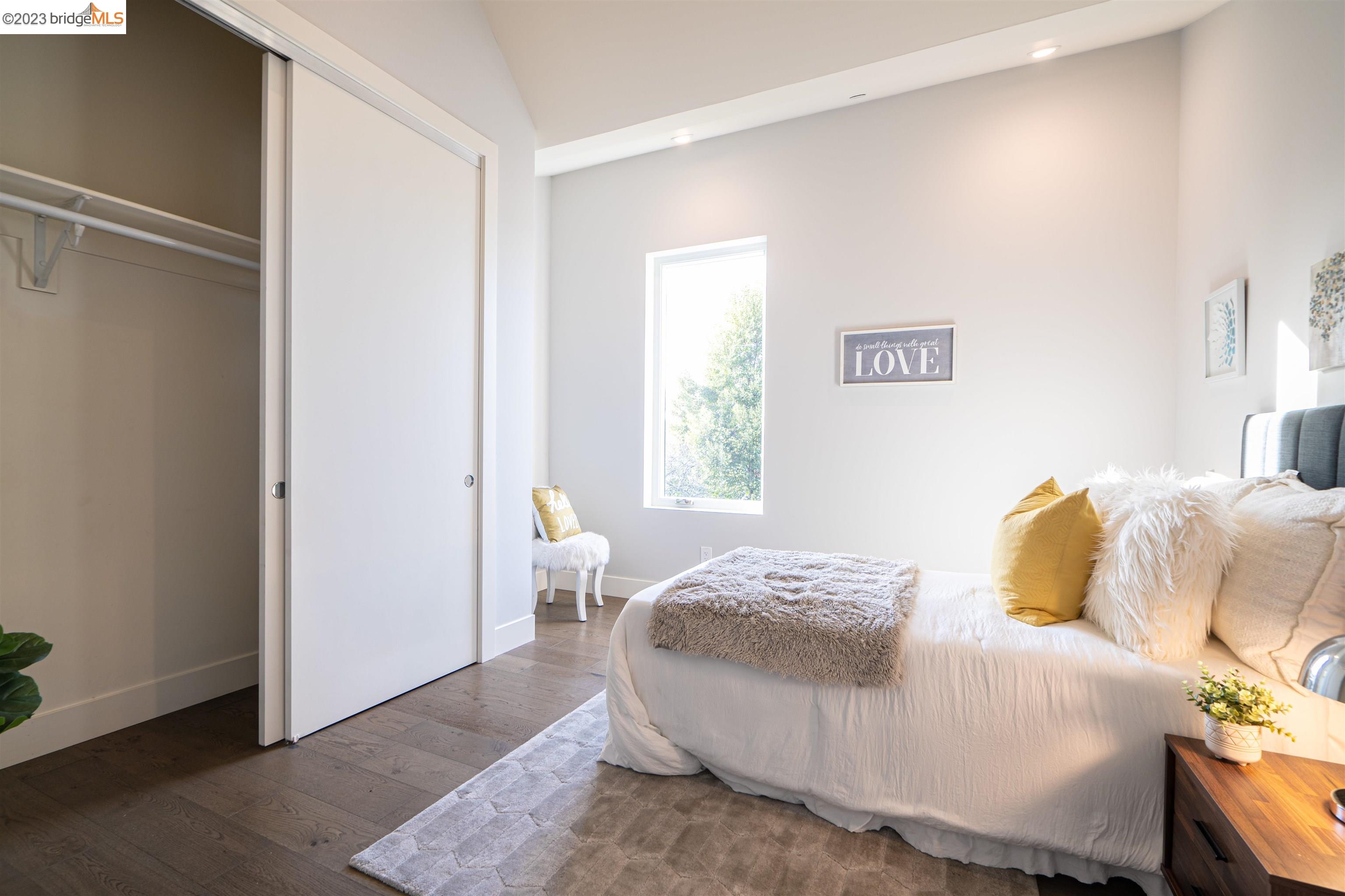 1679 12th Street Oakland, CA 94607 - Photo 17 of 26 a bedroom with a bed and a window