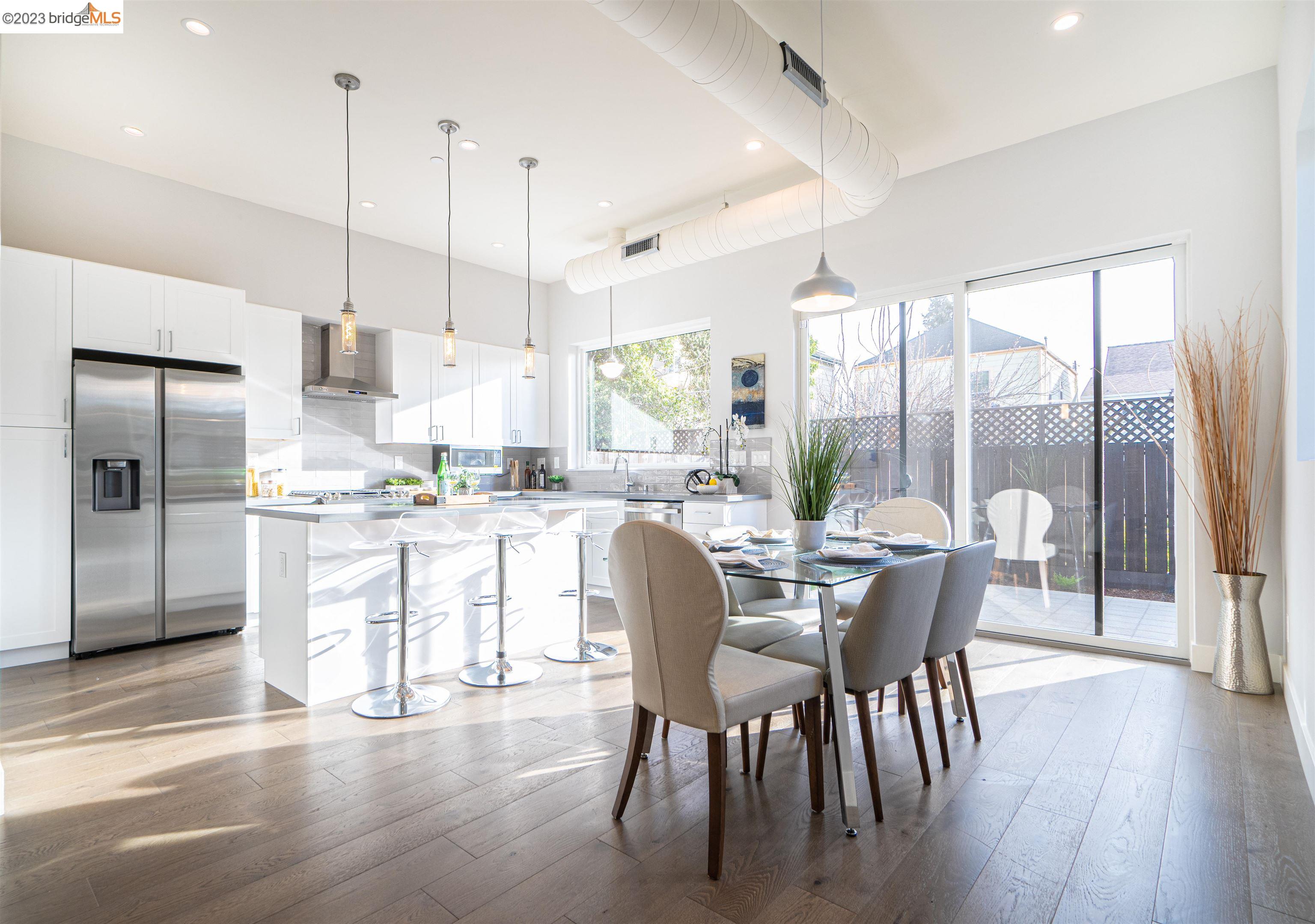 1679 12th Street Oakland, CA 94607 - Photo 3 of 26 a dining room with stainless steel appliances granite countertop a stove top oven a dining table and chairs