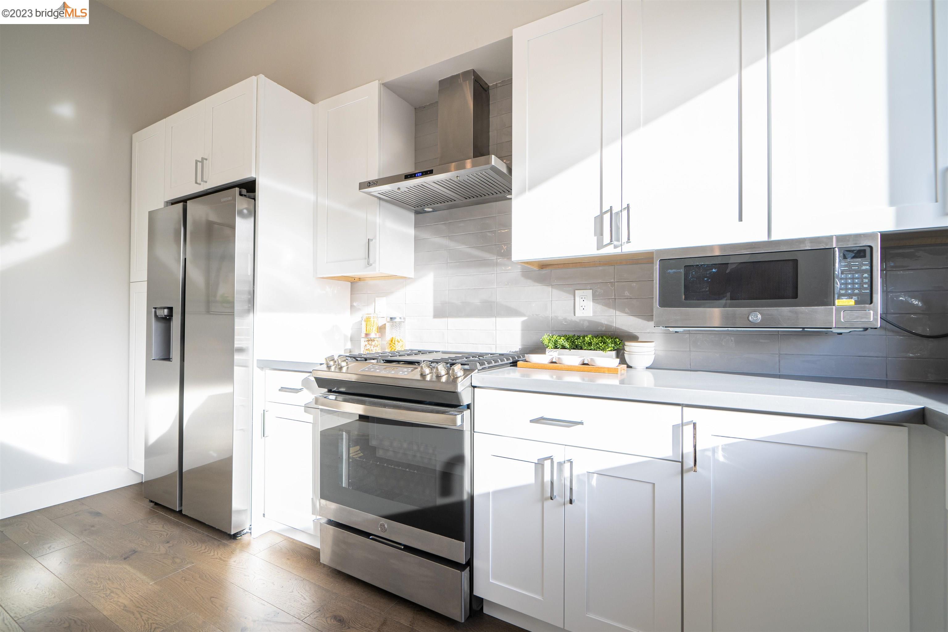 1679 12th Street Oakland, CA 94607 - Photo 7 of 26 a kitchen with cabinets and stainless steel appliances