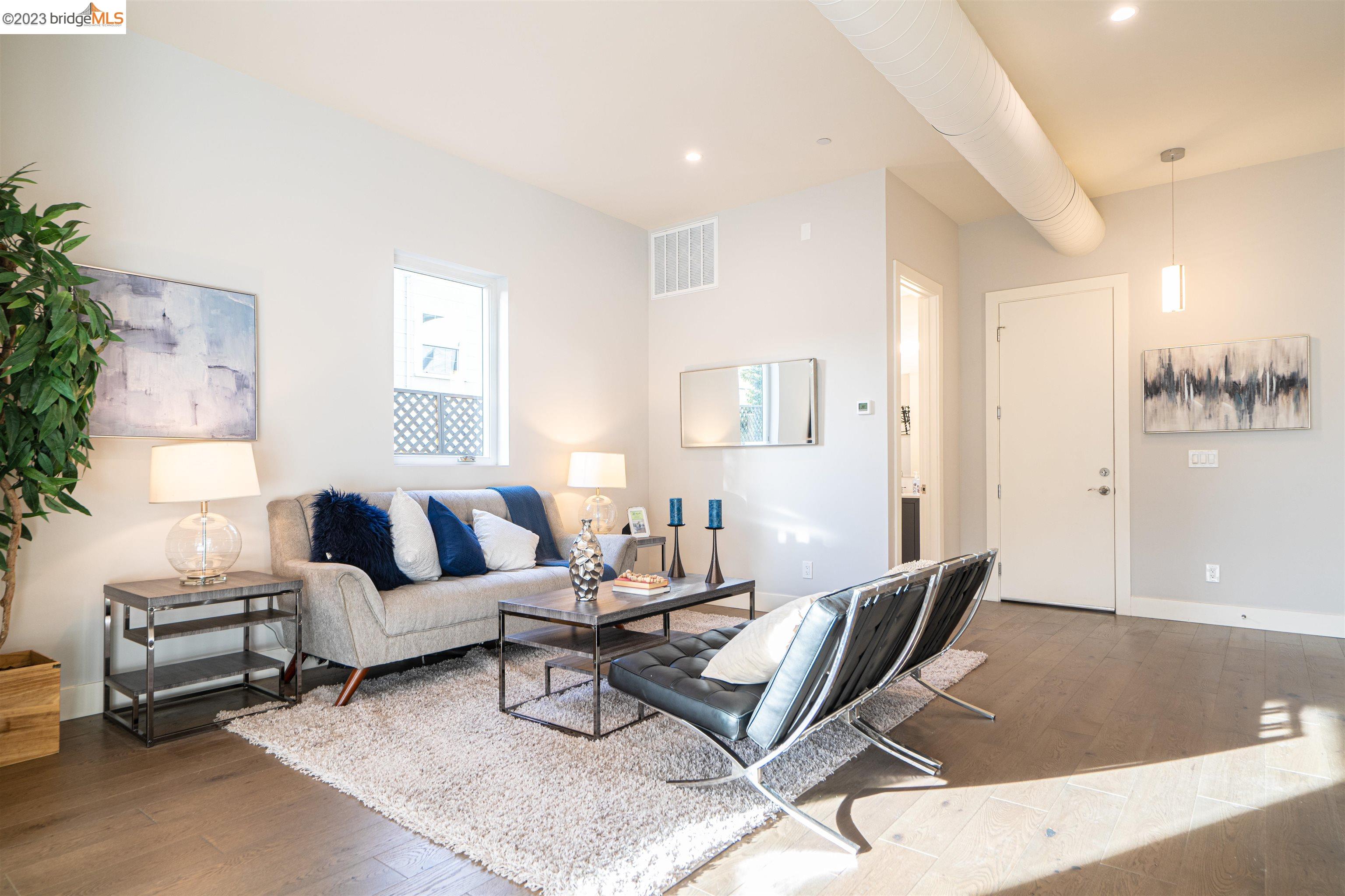 1679 12th Street Oakland, CA 94607 - Photo 9 of 26 a living room with furniture and a wooden floor