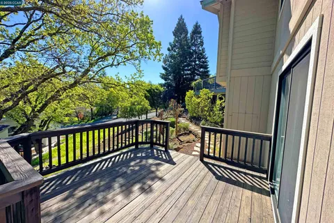 a view of balcony with wooden floor and outdoor seating