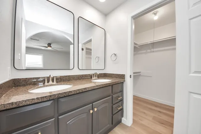 a bathroom with a granite countertop sink a mirror and a