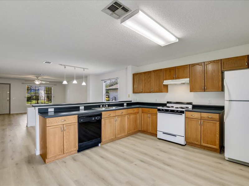 13827 Spring Heath Road Pflugerville, TX 78660 - Photo 8 of 20 A well-equipped kitchen features ample cabinetry, a full suite of appliances, and convenient open-concept access to the adjacent living area.
