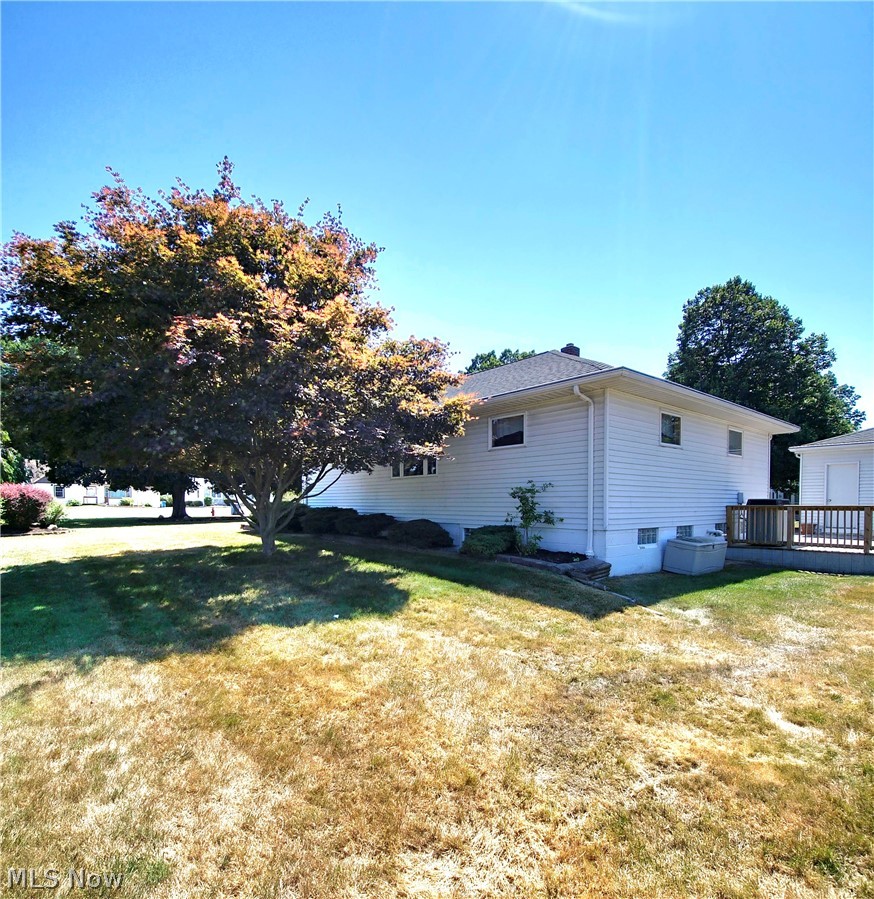 39195 Johnnycake Ridge Road Willoughby, OH 44094 - Photo 19 of 22 View of property exterior with a lawn and a wooden deck