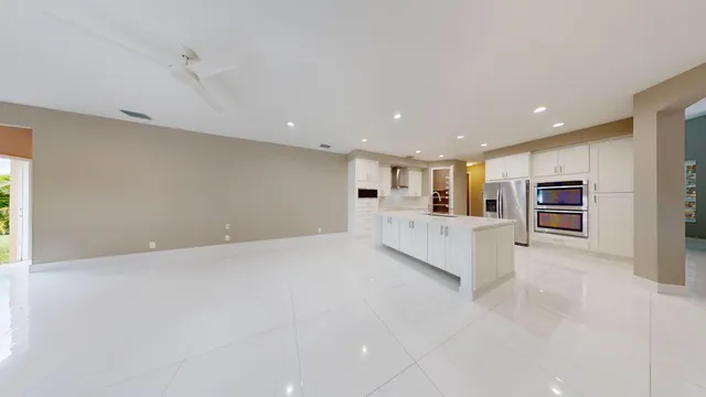 a view of a hallway with a kitchen