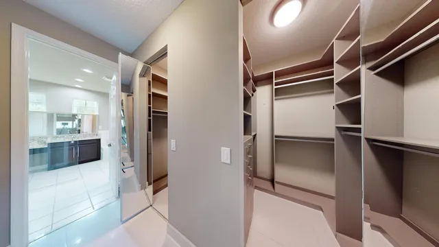 a bathroom with a granite countertop sink a mirror and a bathtub