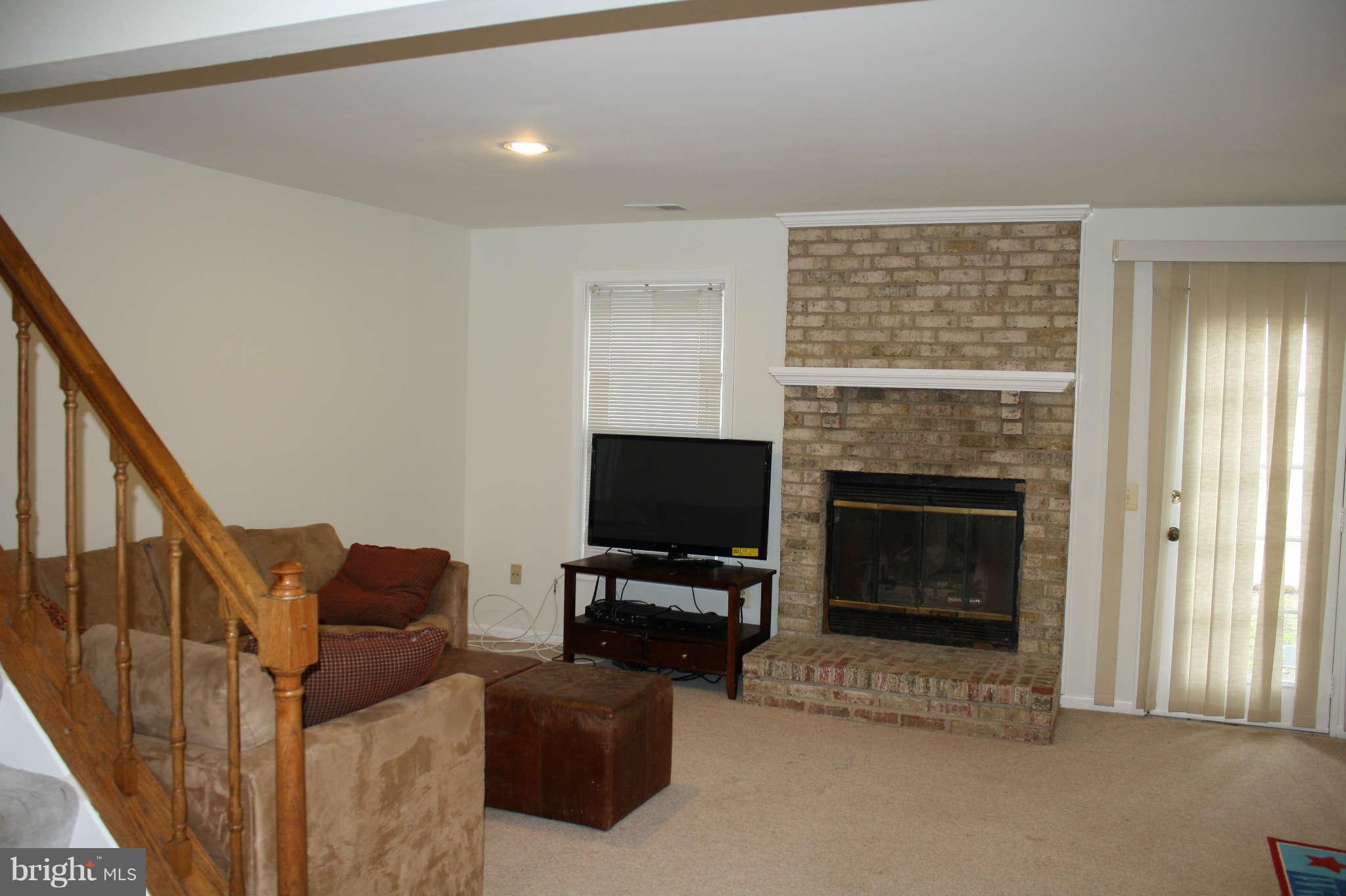 144 Finale Terrace Silver Spring, MD 20901 - Photo 17 of 21 a living room with furniture a flat screen tv and a fireplace