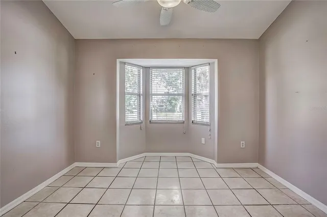 a view of a hallway with wooden floor and chandelier