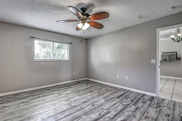 a view of empty room with wooden floor