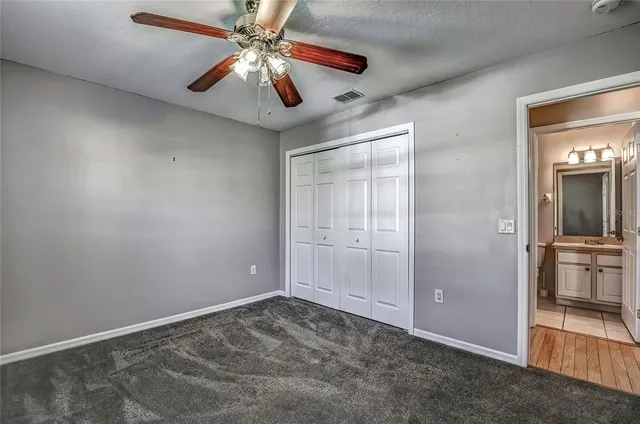 a bathroom with a granite countertop toilet sink and shower