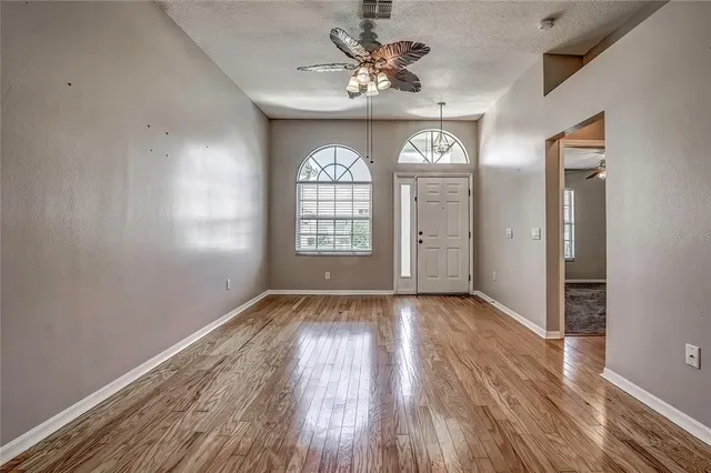 wooden floor in an empty room with a window