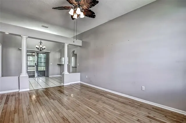a view of empty room with wooden floor