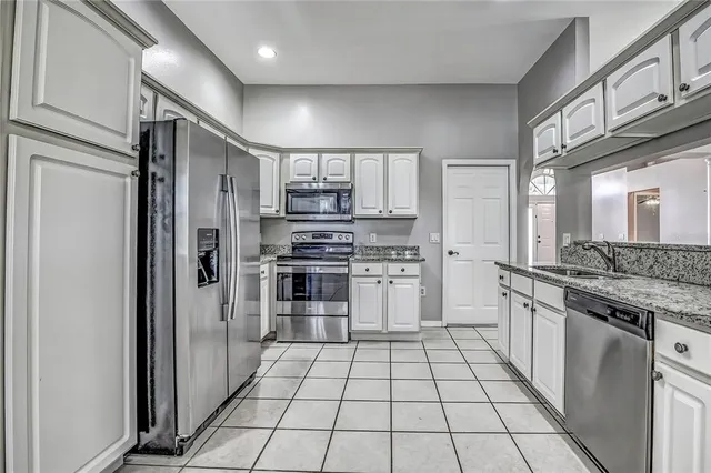 a kitchen with stainless steel appliances a refrigerator sink and stove