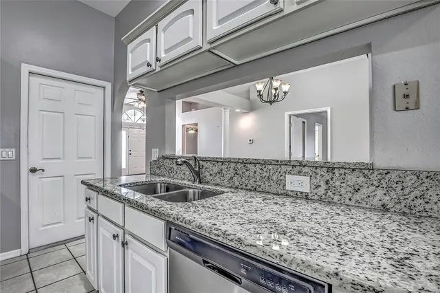 a kitchen with stainless steel appliances cabinets a sink and a counter top space
